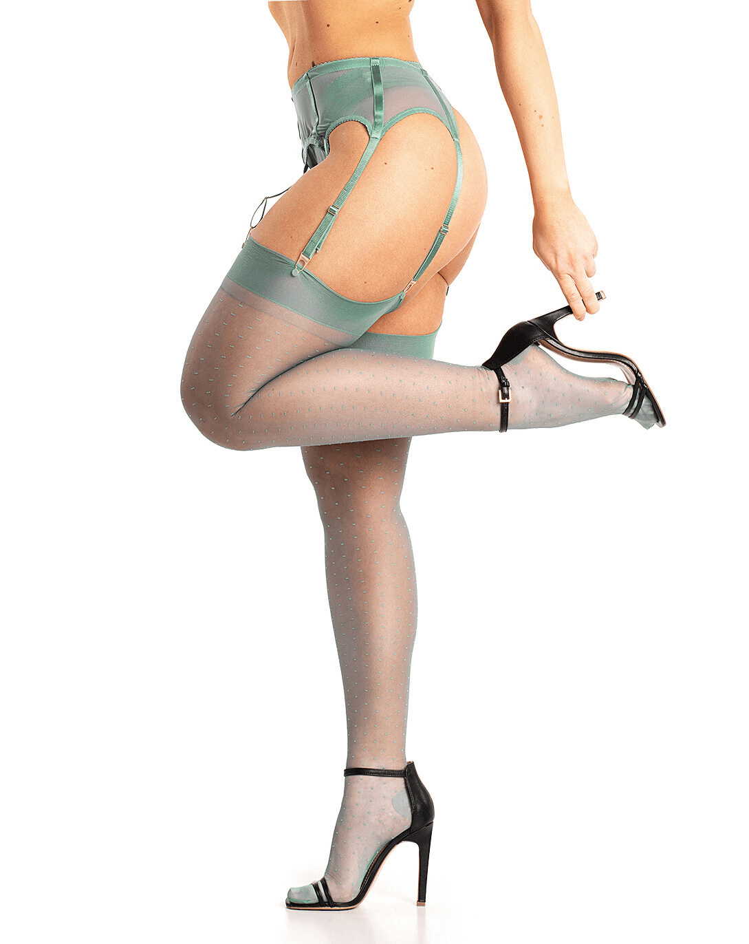 Bottom half of model wearing mint green lingerie against a white background. Side